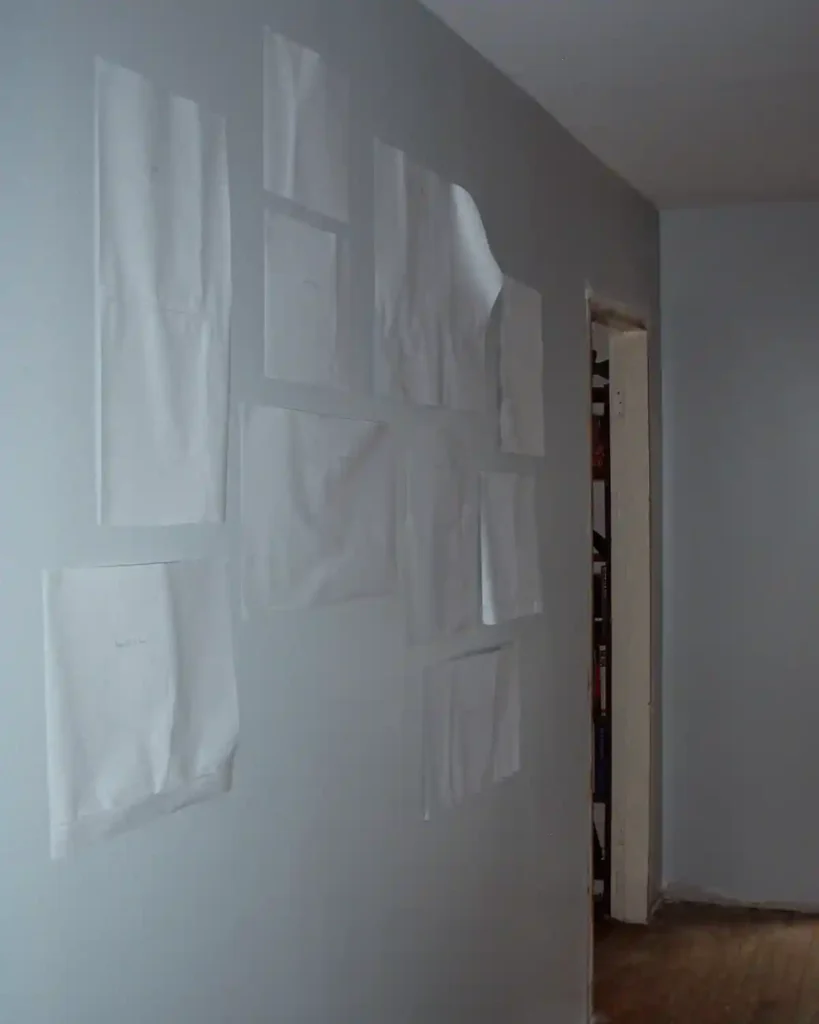 Using scrap paper to mock up a hallway gallery wall