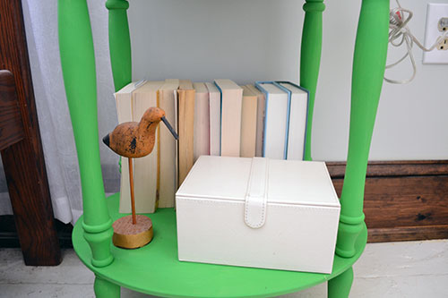 Nightstand Styling With Books And A Wooden Bird