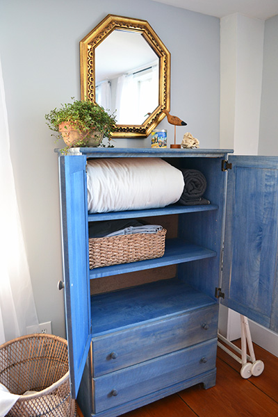 Blue Armoire For Linen Storage In A Guest Room