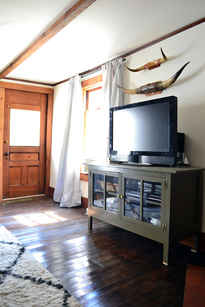 Muddy Green Painted Media Cabinet In A Living Room