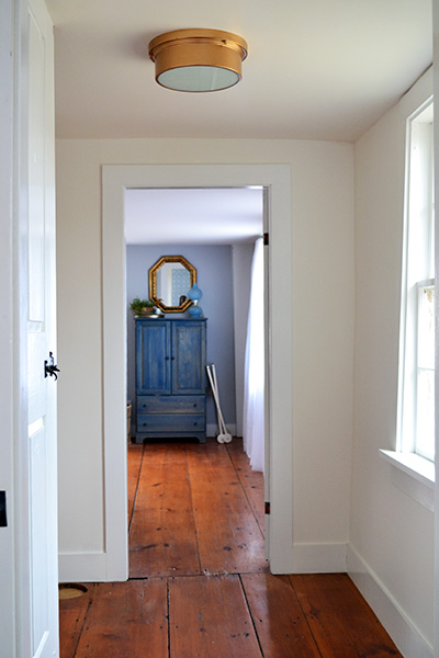 Hallway With Gold Flush Mount Light Fixture