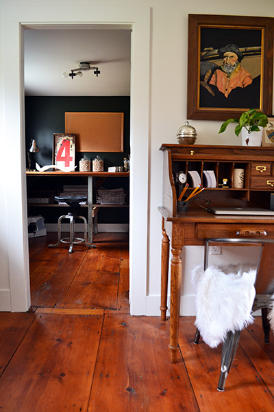Small vintage rolltop desk in a landing with wide pine floors