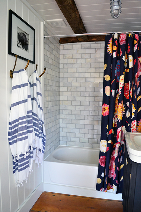 Bathroom renovation reveal. Decorating with an Anthropologie shower curtain and blue striped Turkish bath towels.