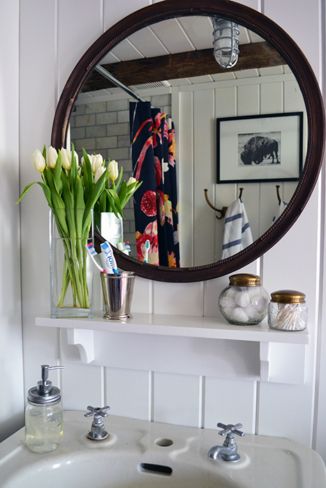 Vintage mirror hanging in the bathroom was refinished with Rub 'N Buff Spanish Copper.