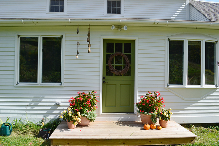 White colonial farmhouse with green door