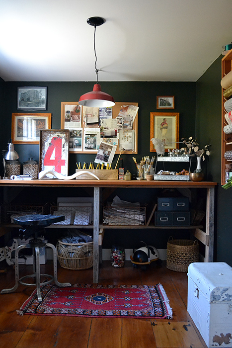 Dark craft room with a red farmhouse light fixture