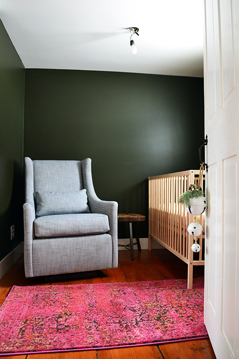 A pink rug in the nursery that's too small for the space