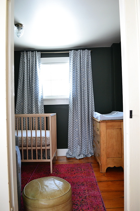 Blue nursery curtains from Anthropologie in a dark nursery