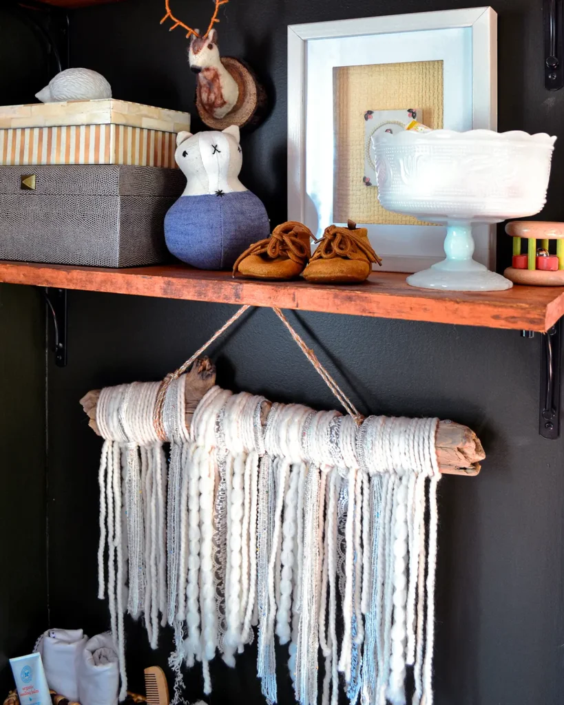A DIY wall hanging made out of yarn adds texture as a dark nursery ideas option
