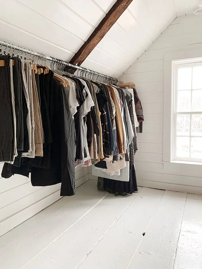 Hanging clothes in a finished attic walk-in closet