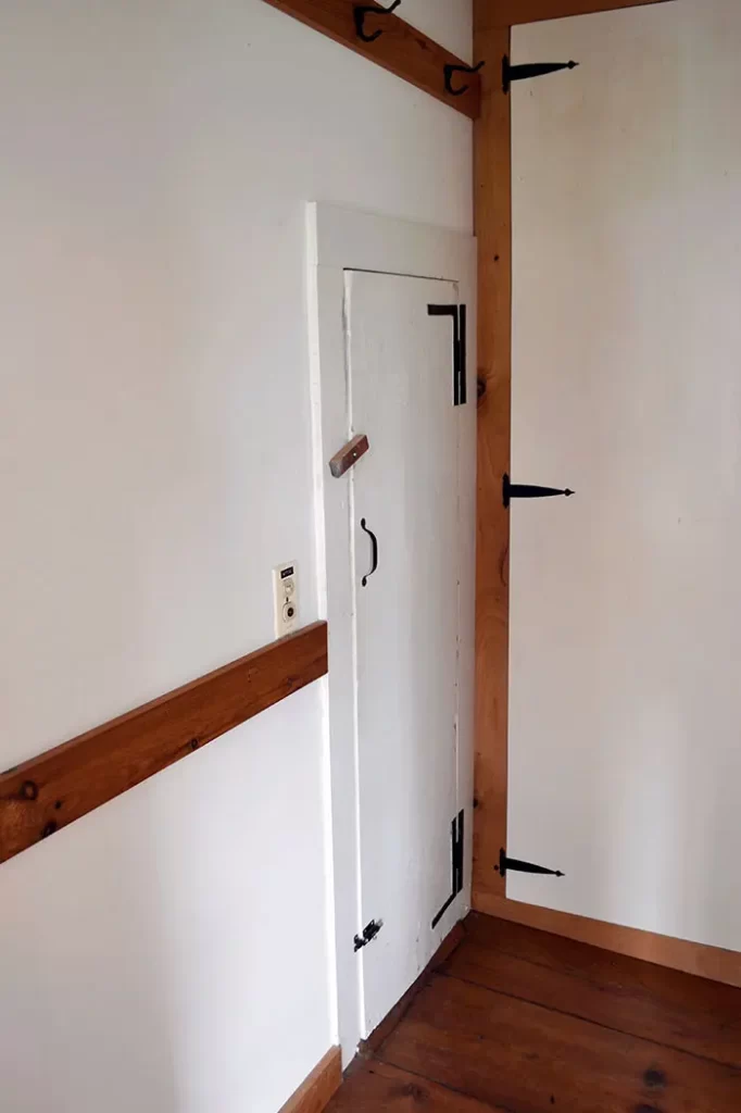 Door from primary bathroom that leads into a small attic space