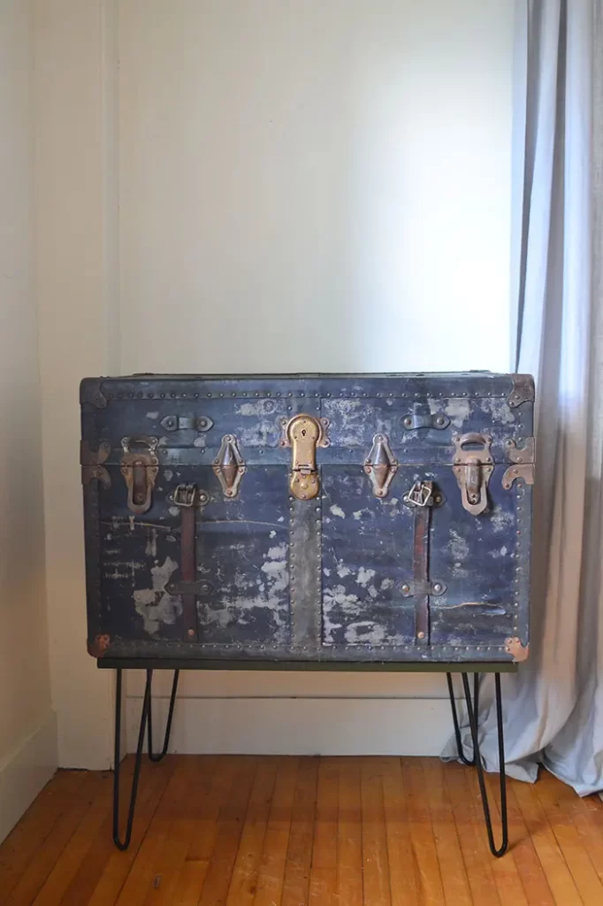 Vintage steamer trunk turned into a console table by adding hairpin legs to the bottom