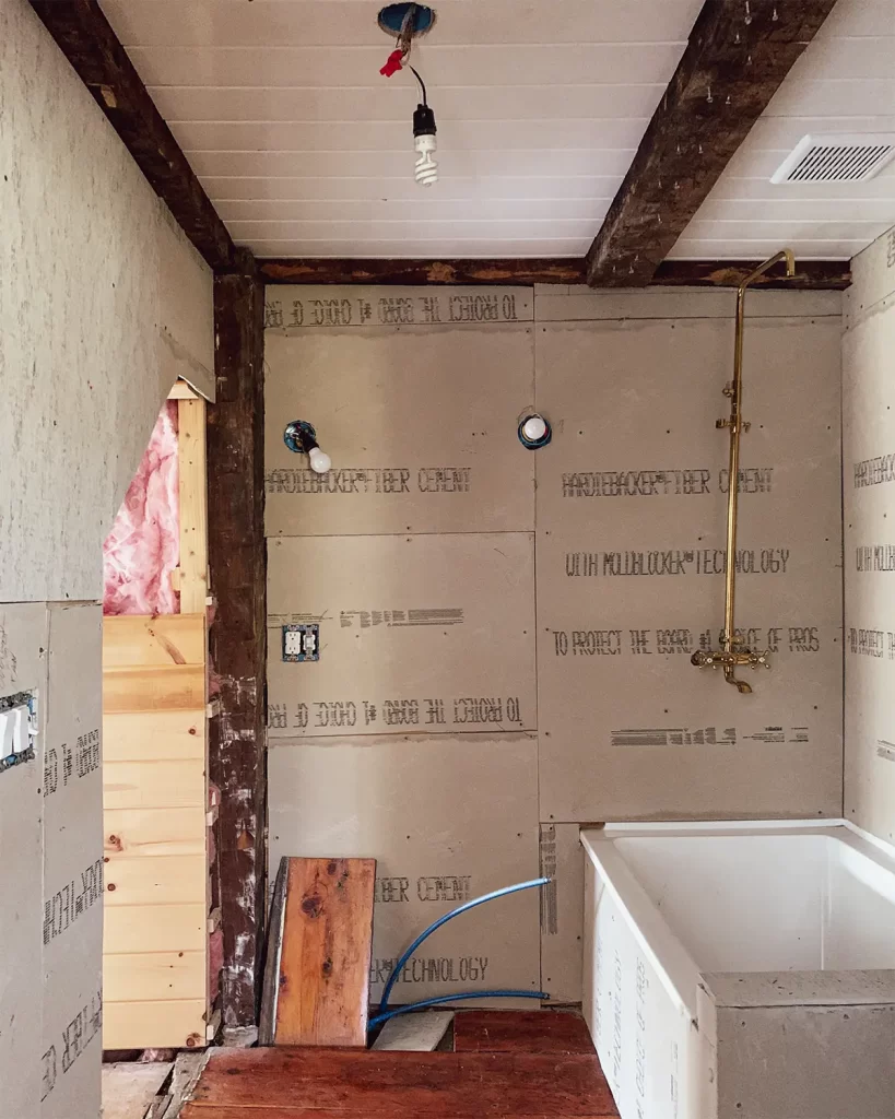 Bathroom renovation with tongue and groove ceiling planks installed with exposed wood beams