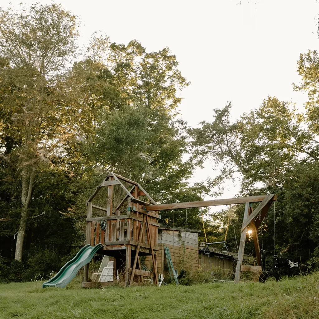 Old outdoor playground with a horse tire swing ready to be updated