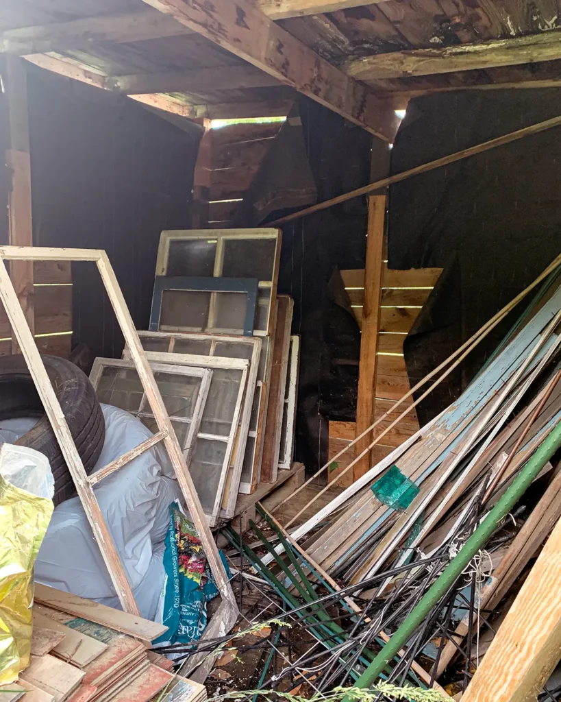 The interior of the old shed is super messy. First step to converting the shed to a playhouse is cleaning out the space.