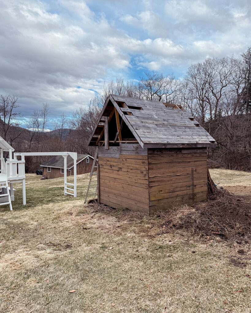 Building progress for a playhouse with a roof being raised and constructed