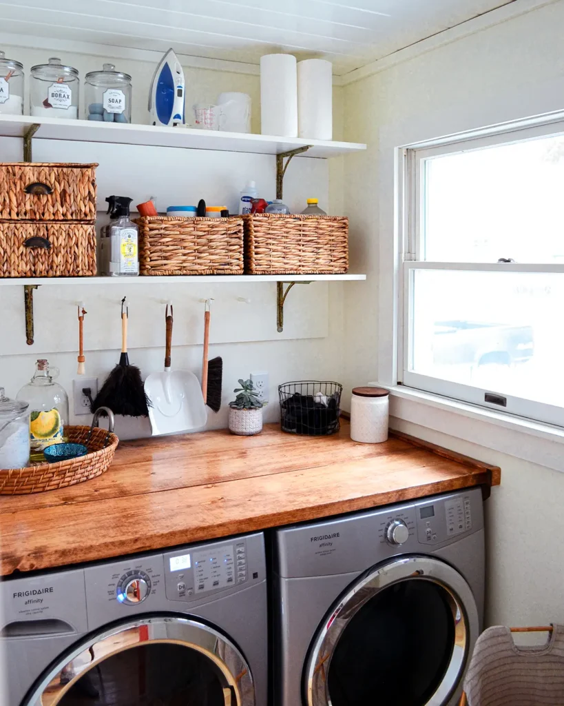 Laundry room open shelves with lesser used items stored on the top shelf and regularly used items like cleaning products stored on the bottom shelf