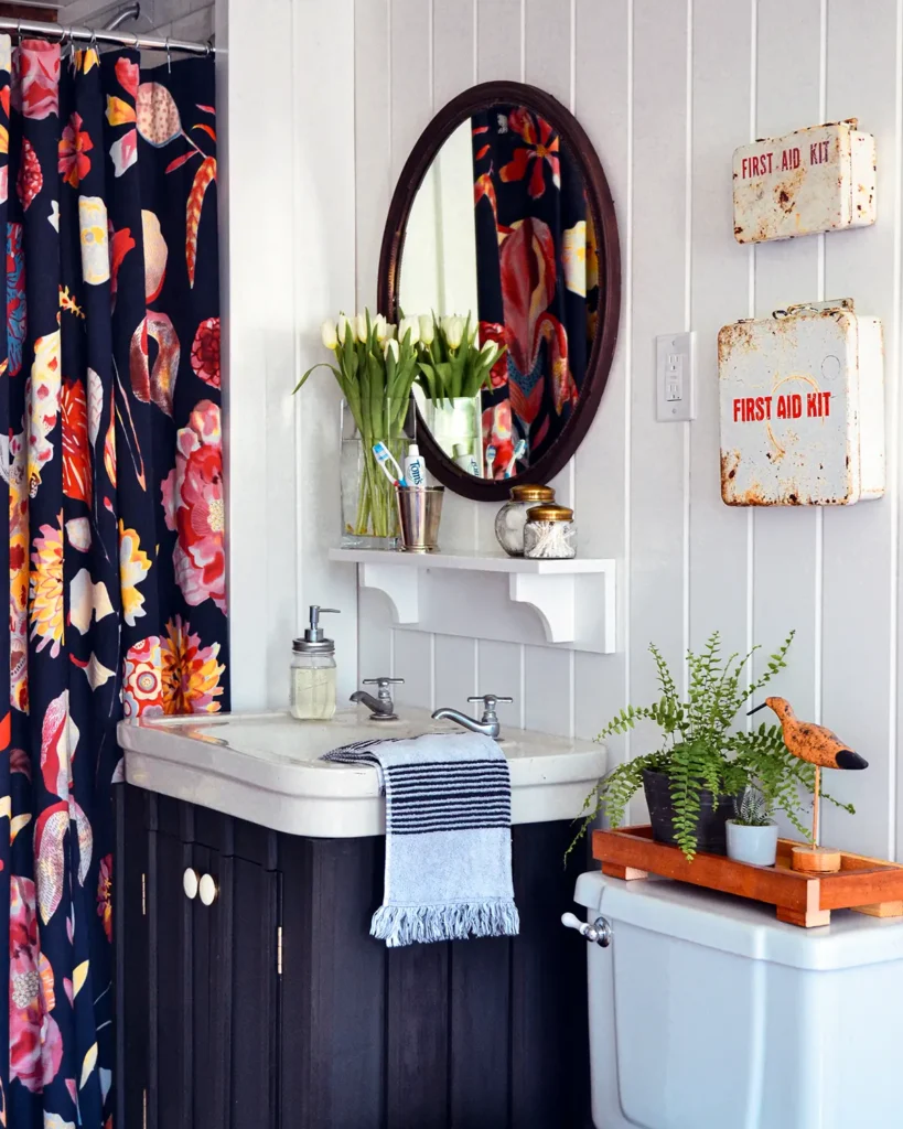 Bathroom renovation after photo with a colorful Anthropologie shower curtain, DIY vanity project, and shiplap walls