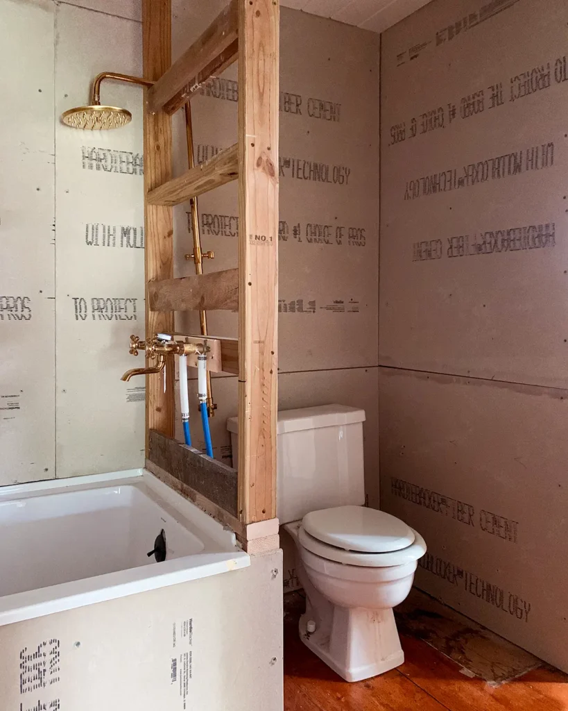 Framing a DIY bathroom wall in a small bathroom