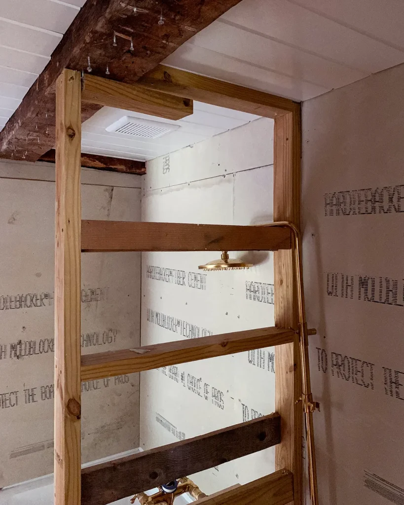 Framing a wall around an exposed beam in a bathroom ceiling