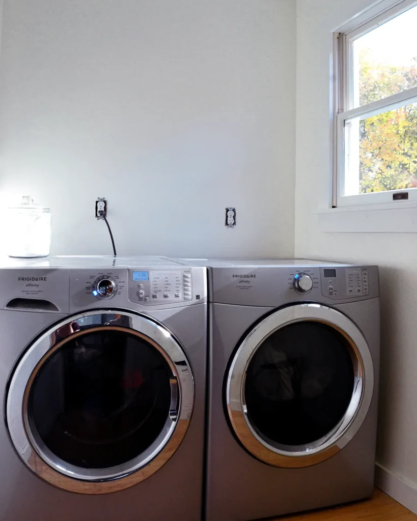 Fresh coat of white paint in a laundry room with a new pair of laundry machines for a blank slate