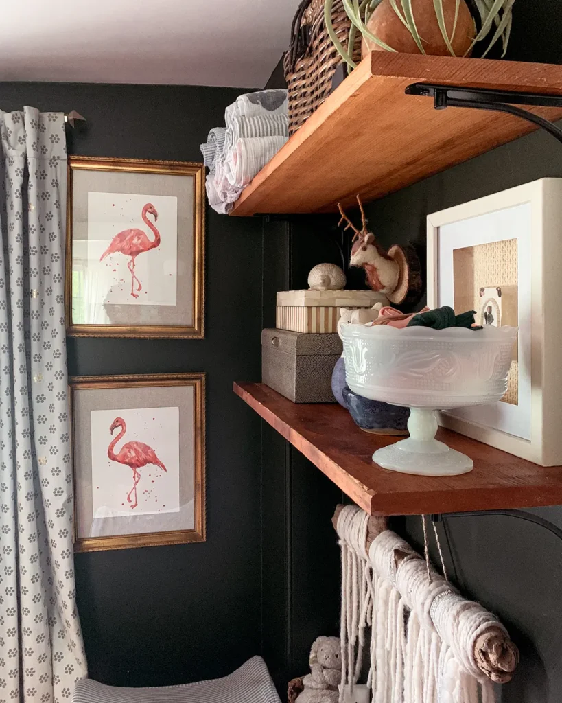 Open shelves in a small nursery organized with baby's most used things like a bowl of hair bows and boxes with first aid