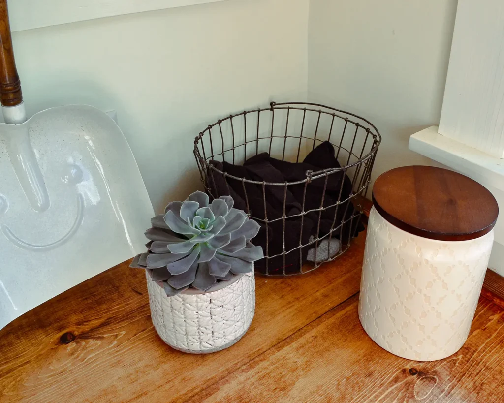 Using a vintage egg basket on a laundry countertop to hold socks with a missing mate in a a laundry room