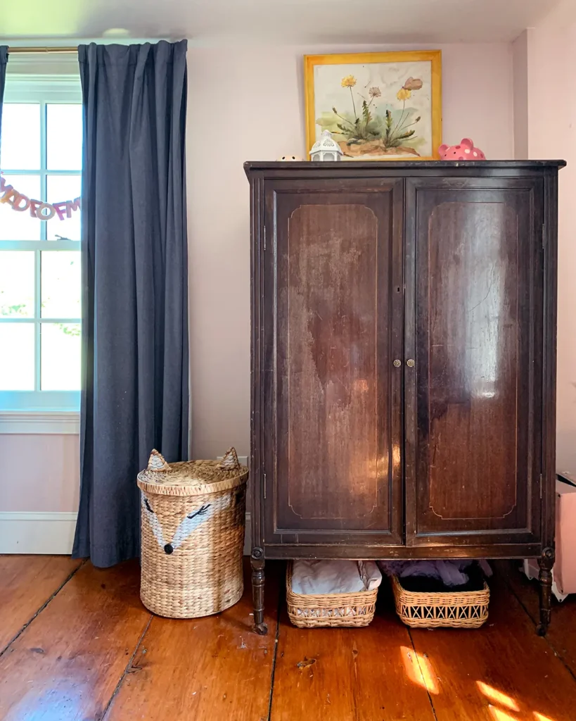 Antique wardrobe for clothes storage in a girl's bedroom