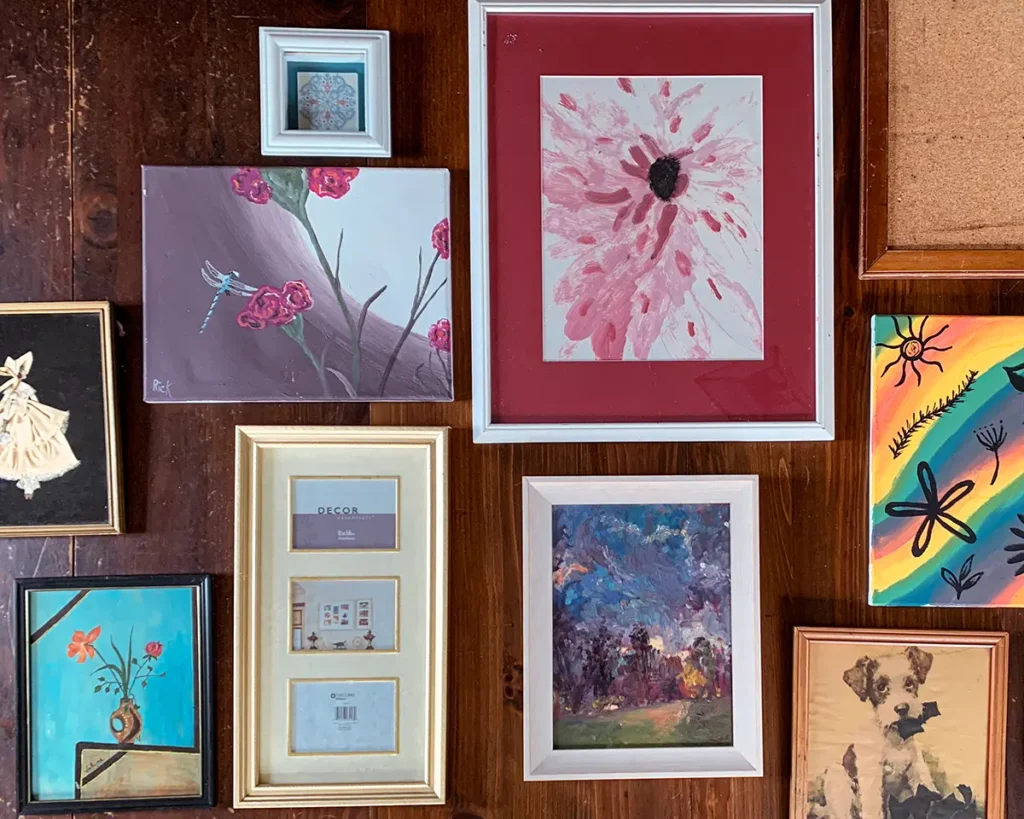 Thrift haul of collected art from secondhand shops to decorate a kid's bedroom