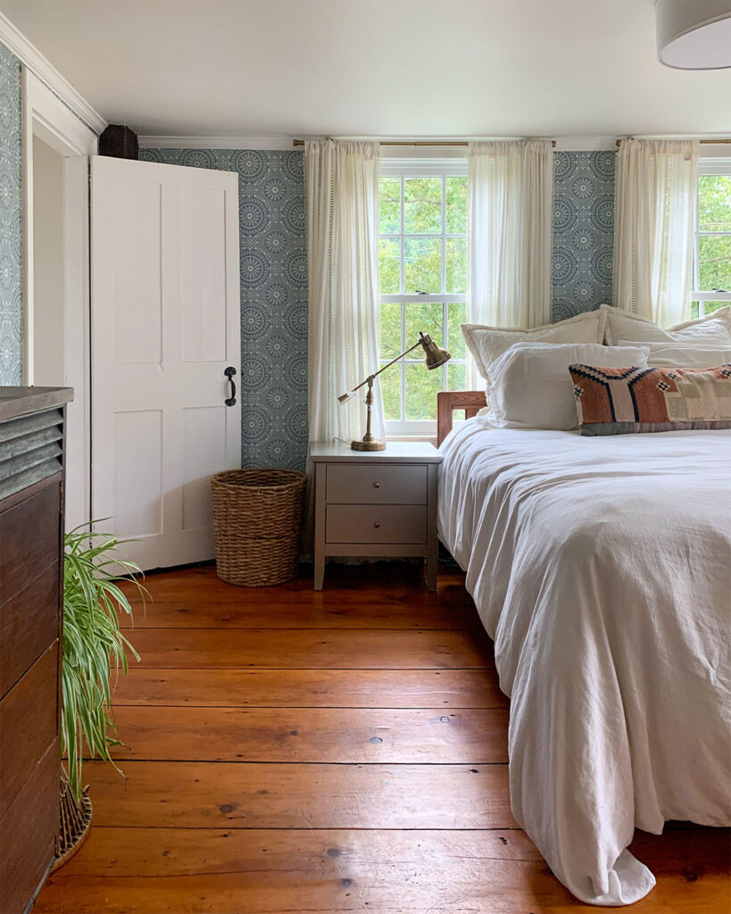 Bedroom refresh ideas and a bedroom before photo of our bedroom with wide pine floors, vintage blue wallpaper , and white bedding