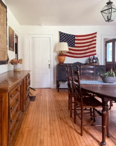 Dining room with a chalk painted buffet with American flag above it
