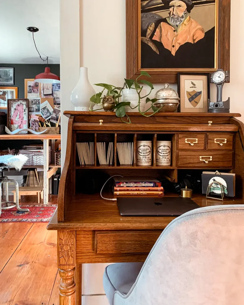 Original wood stain on vintage roll top desk in hallway in front of craft room