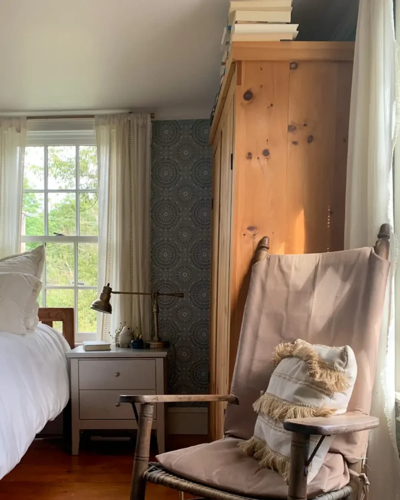 Before refinishing the pine wardrobe and the laminate nightstand in this bedroom with a vintage rocking chair