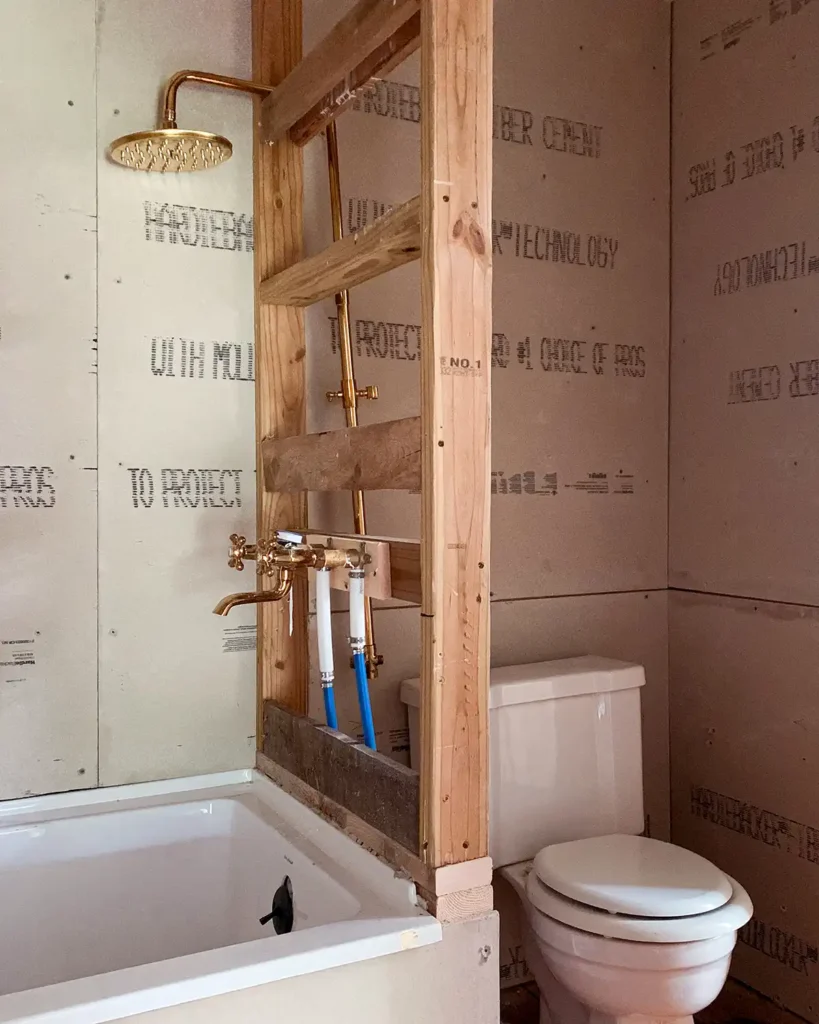 With four distinct phases of a bathroom remodel, the construction phase often takes the longest to DIY, framing the shower and updating plumbing 