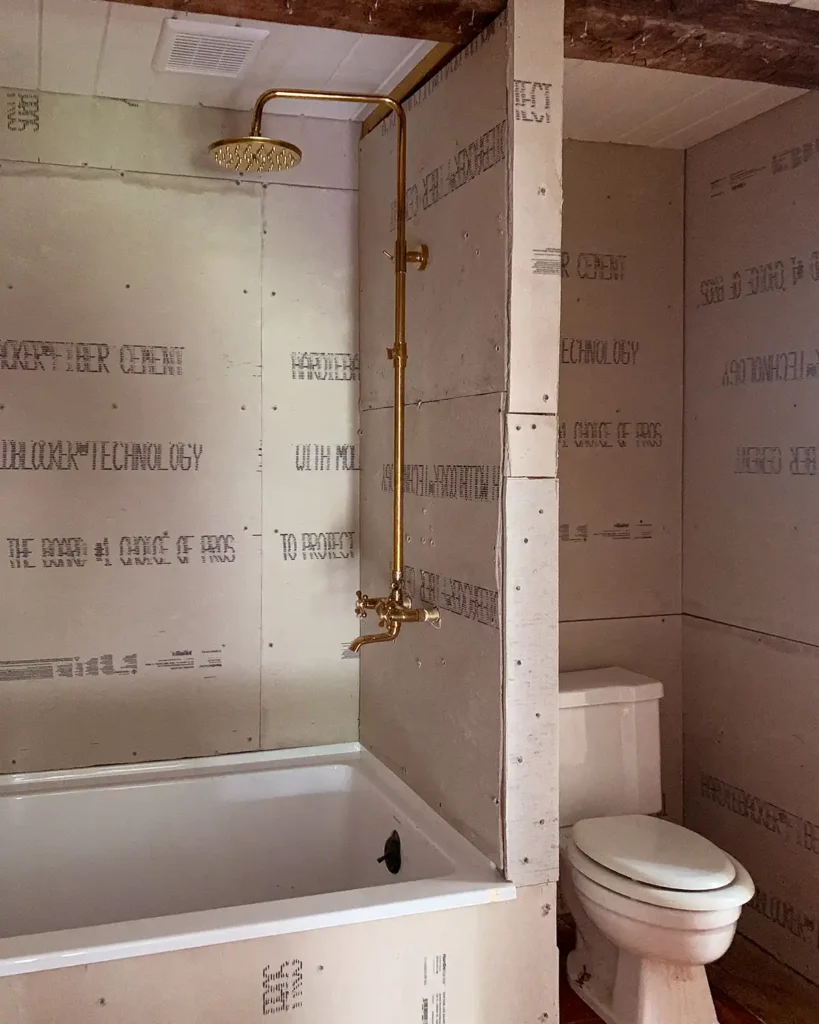 Bathroom remodel schedule with construction phase finished, cement board hung on bathroom walls and toilet nook framed in