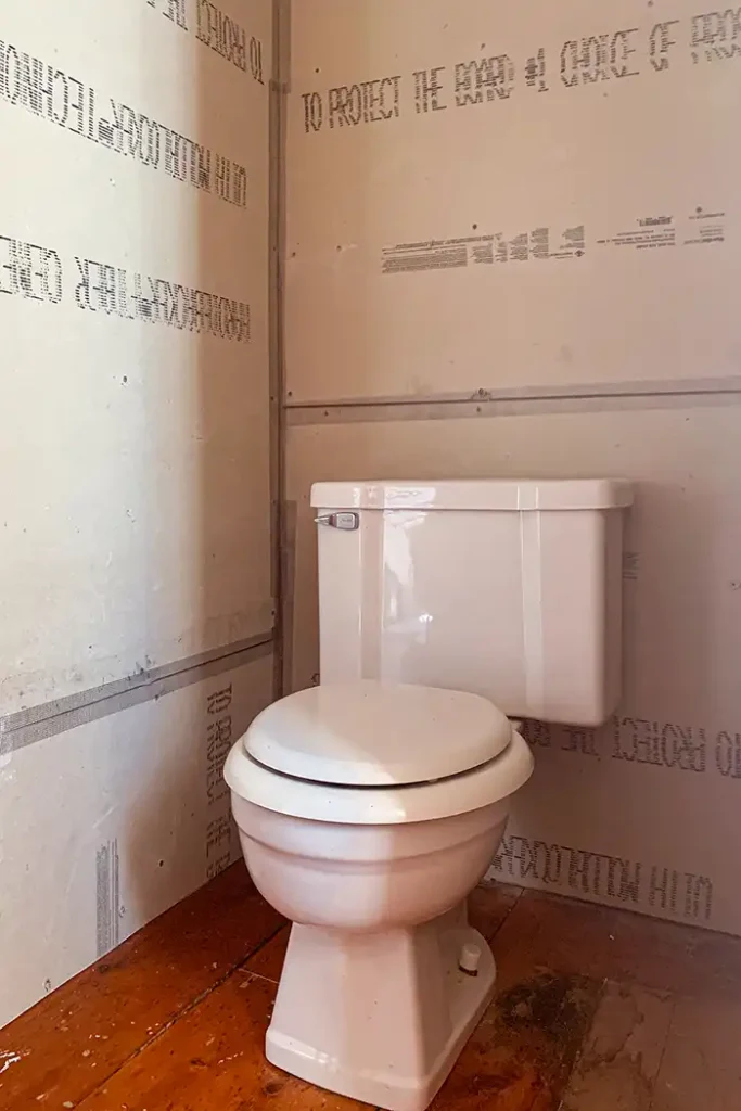 Bathroom remodel schedule featured image, toilet nook with taped cement board walls