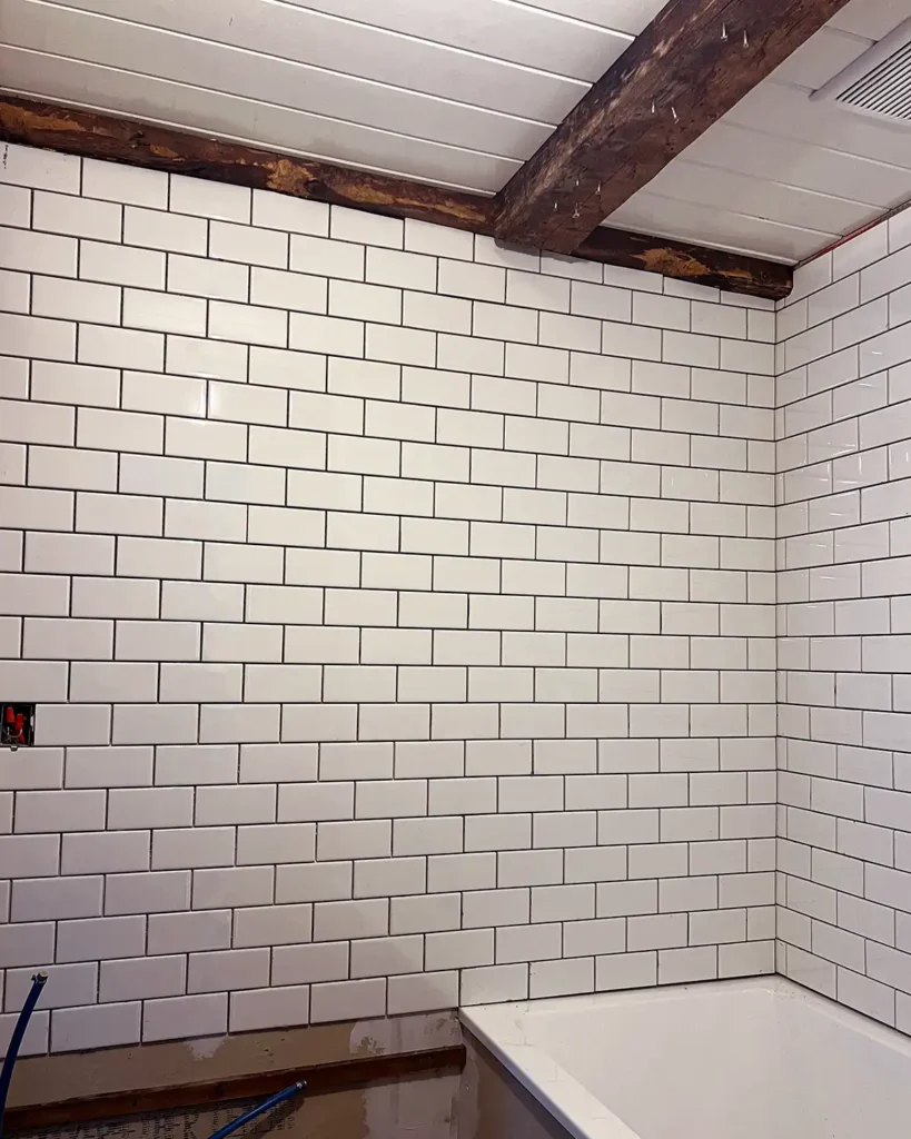 Bathroom renovation subway tile installation progress