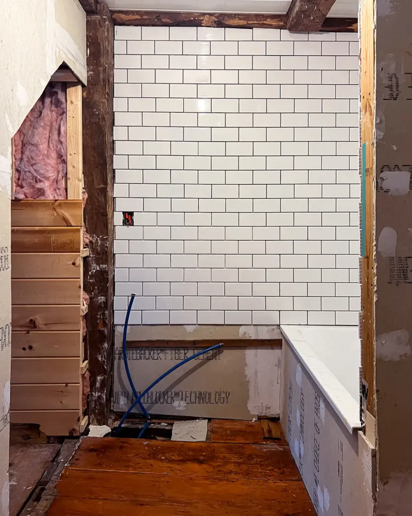 DIY bathroom renovation subway tile work progress