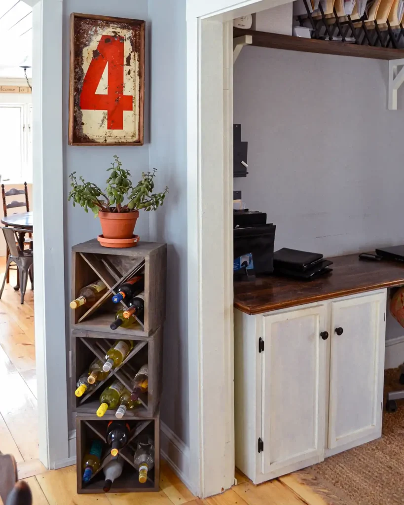 Gray stain on a DIY wine rack in a dining room with a red nautical sign hanging above it