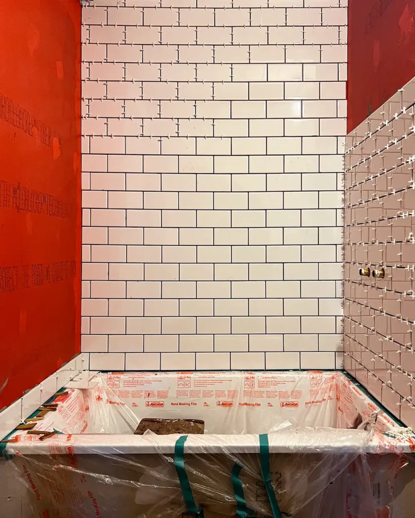 Shower surround tiling day 3 installing white subway tile in a shower