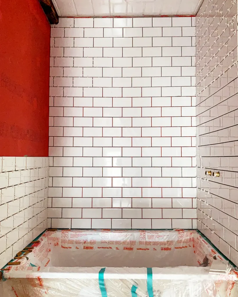 Day 4 of installing white subway tile in a shower surround