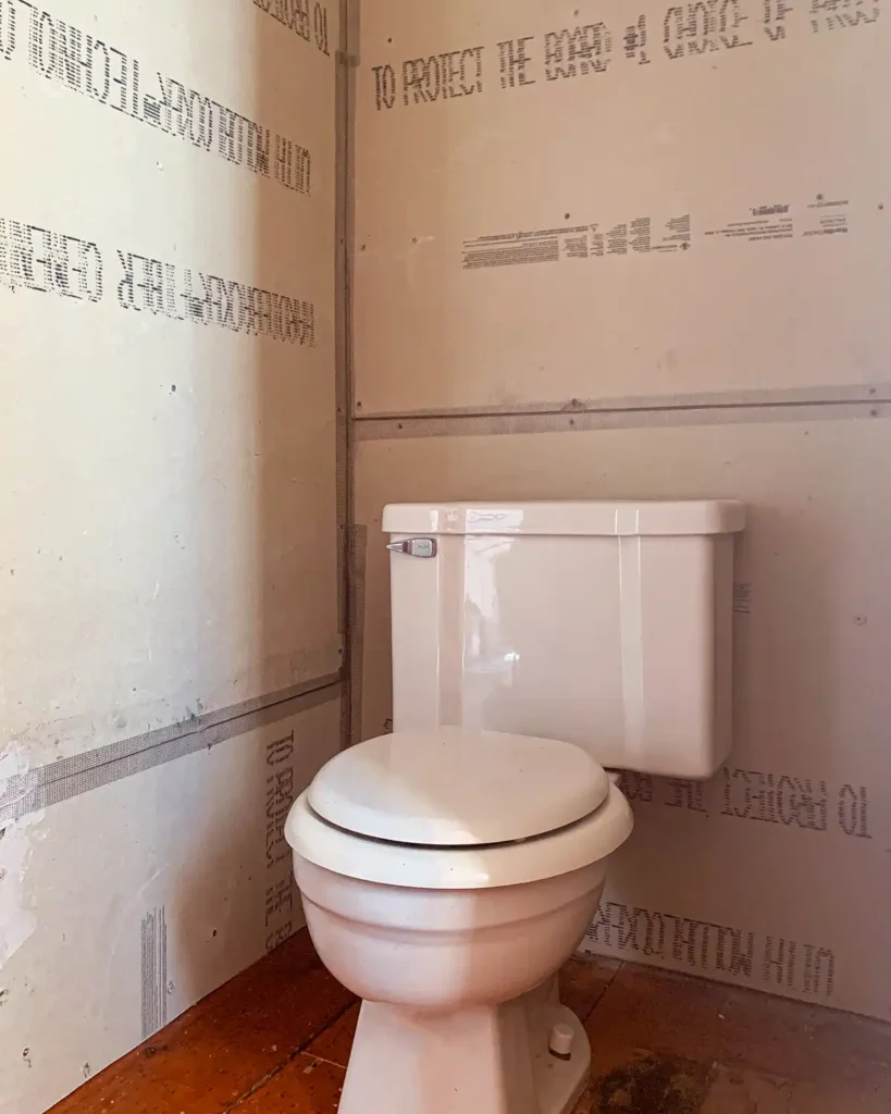 Bathroom cement board walls around toilet with joints taped