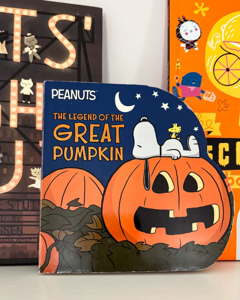 "It's the Great Pumpkin Charlie Brown" board book on a kid's bookshelf