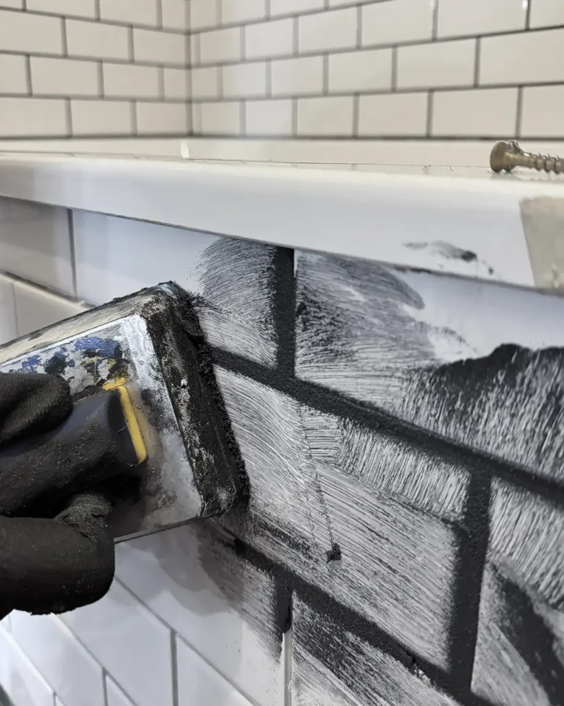 Grouting white subway tile with black grout using a float