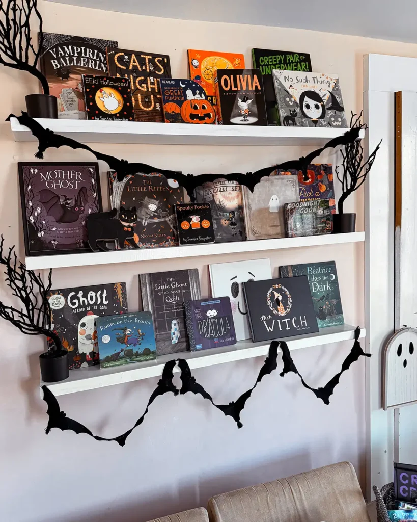 Halloween books for kids including picture books and board books, on shelves in a kids room decorated for Halloween