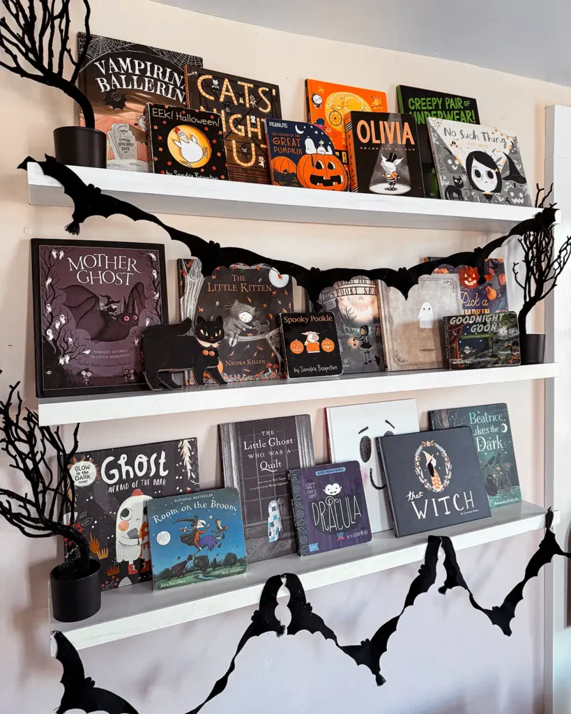 Halloween picture books on open shelves in a kid's room decorated for Halloween