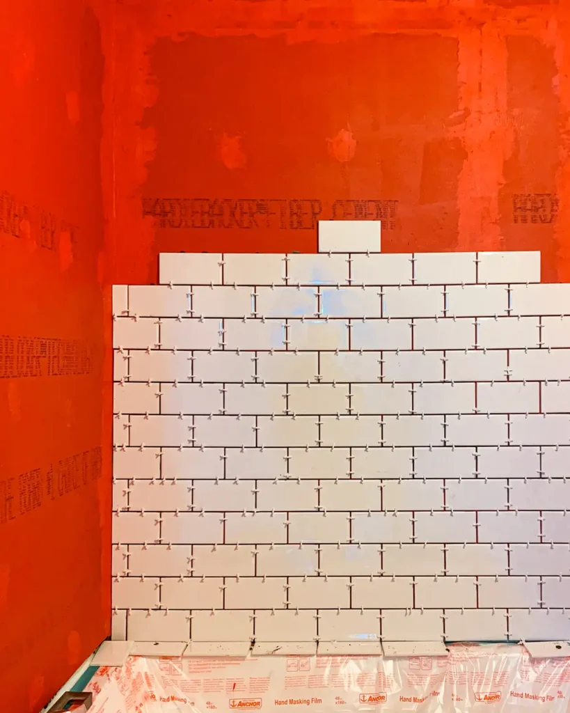 How to waterproof a tile shower using RedGard liquid membranes, installing white subway tile on top of waterproofing