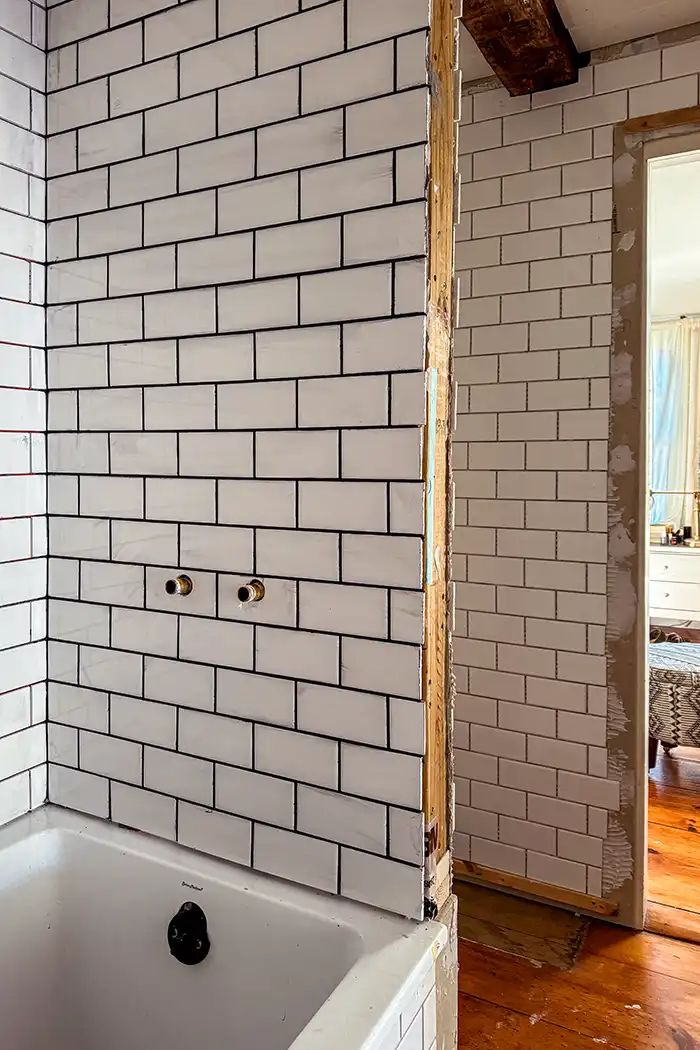 One Room Challenge Fall 2024 Week Six Featured image, grouted white subway tile in a small bathroom renovation progress shot