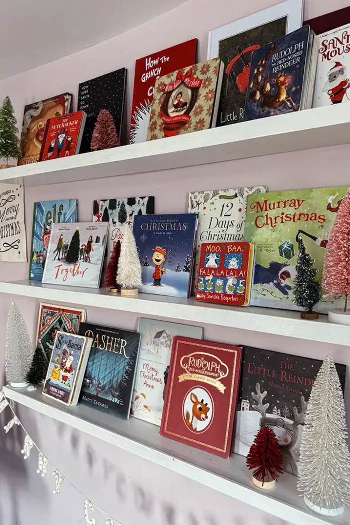 Christmas picture books featured image with the best Christmas picture books for kids on an open bookshelf in a kid's bedroom decorated for Christmas