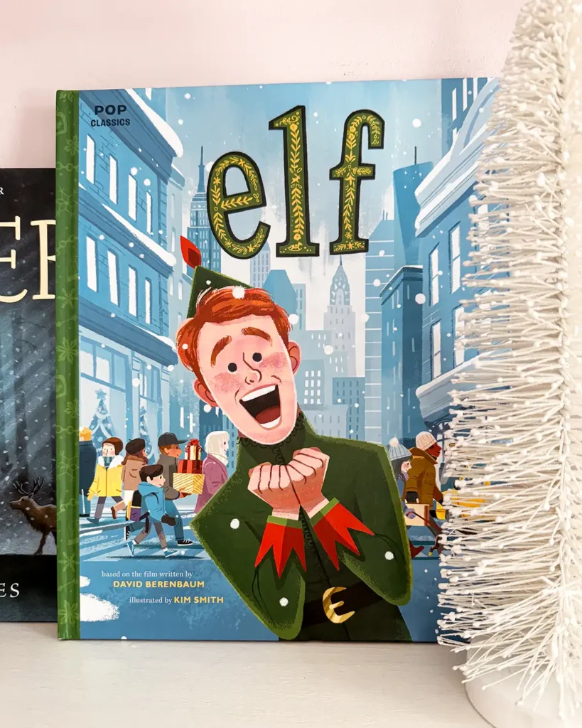 Elf Pop Classics picture book on a child's bookshelf decorated for Christmas with bottle brush trees